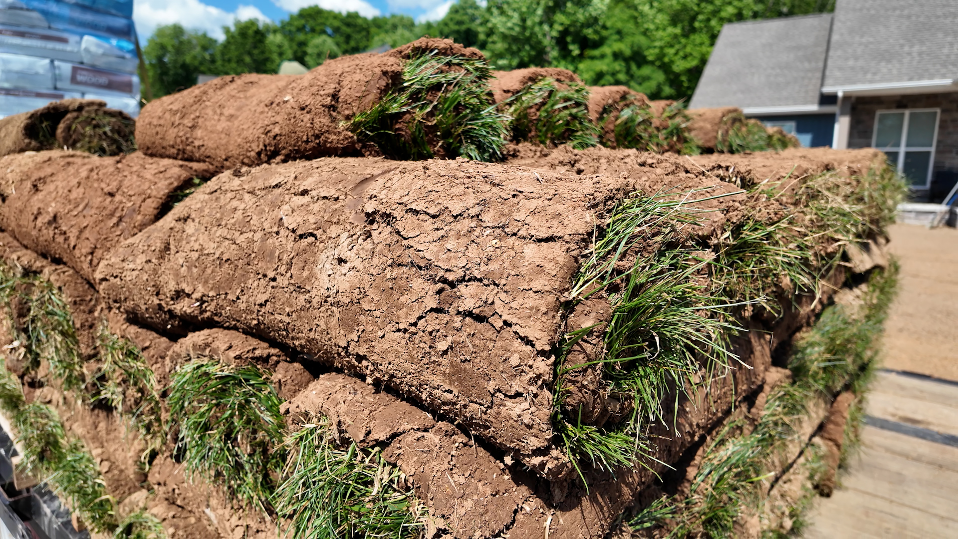 stack of sod turf rolls on truck trailer